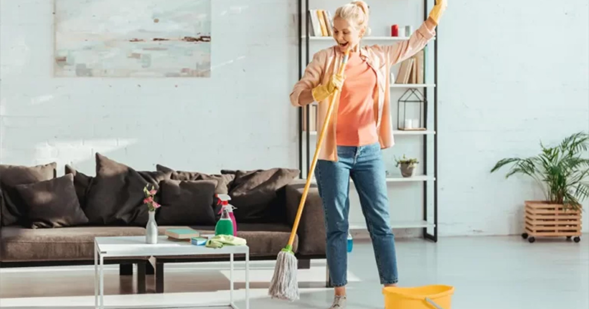 A-women-happily-cleaning-the-home-with-good-tools