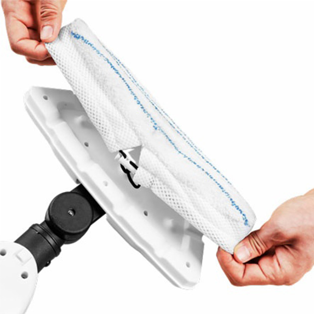 Una persona está volviendo a montar la almohadilla de limpieza de la aspiradora.